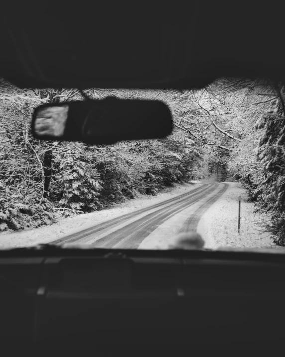 a black and white po of a snowy road