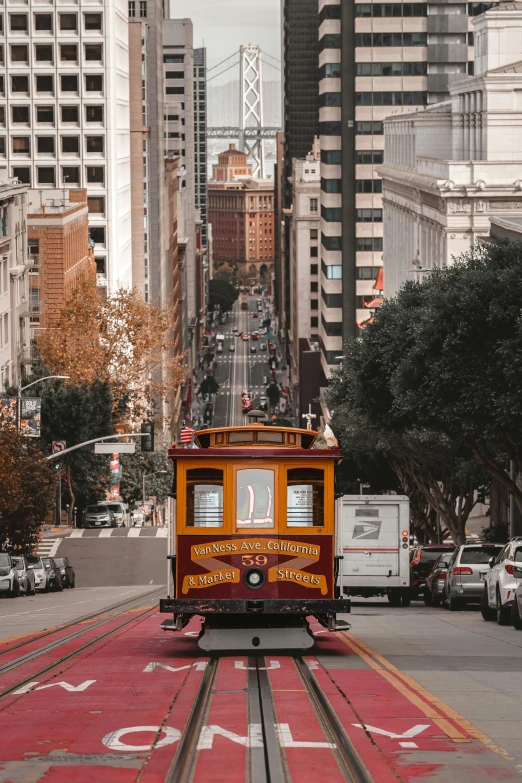 a trolley car moves down the tracks in san francisco