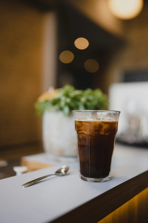 a cup with a liquid inside sitting on a counter