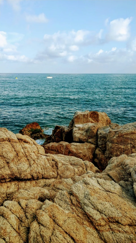 large rocks with sea in the background