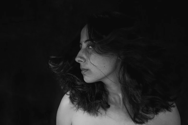 a black and white po of a woman wearing an off shoulder shirt