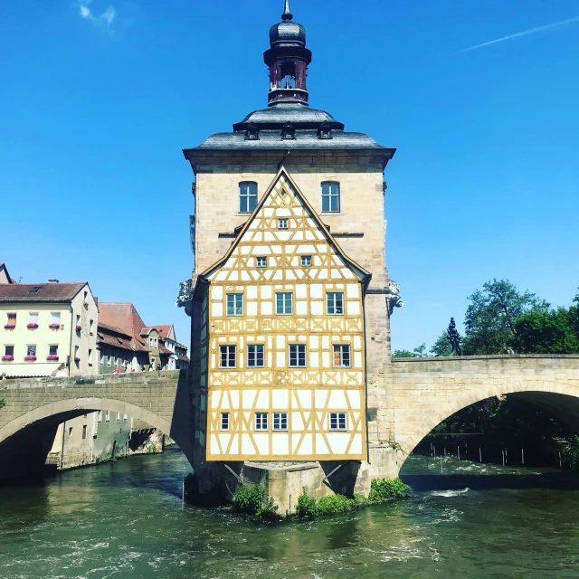 a building with a tower is shown above a river