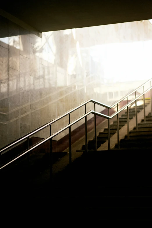 a man is walking up a staircase with his umbrella