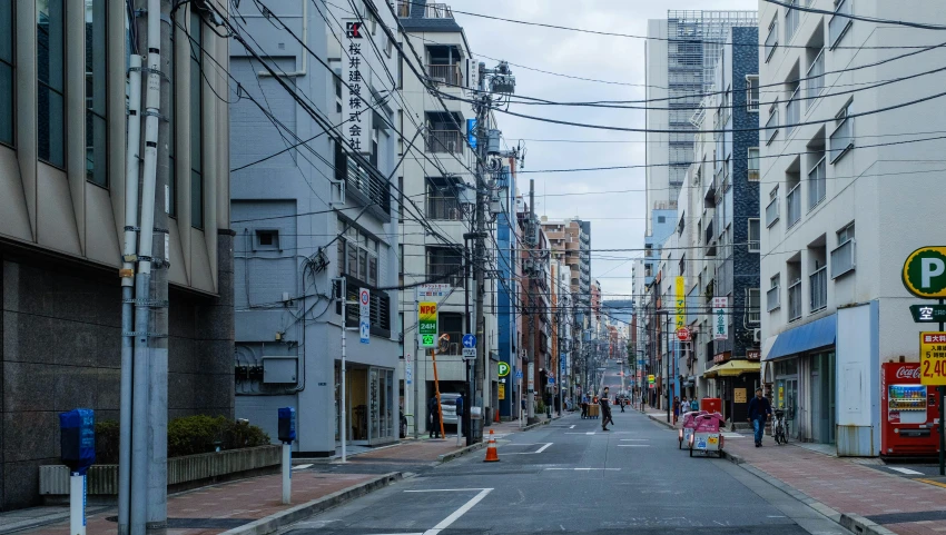 some buildings and wires are on a street