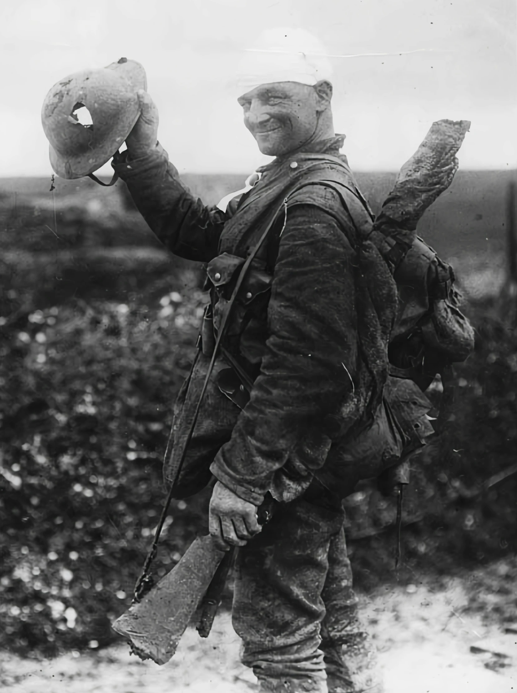 an old man in military gear holding a large bag