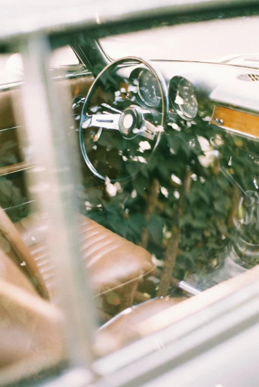 an old style car with a flower arrangement on the dashboard