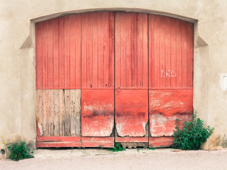 a red and brown gate on an outside wall