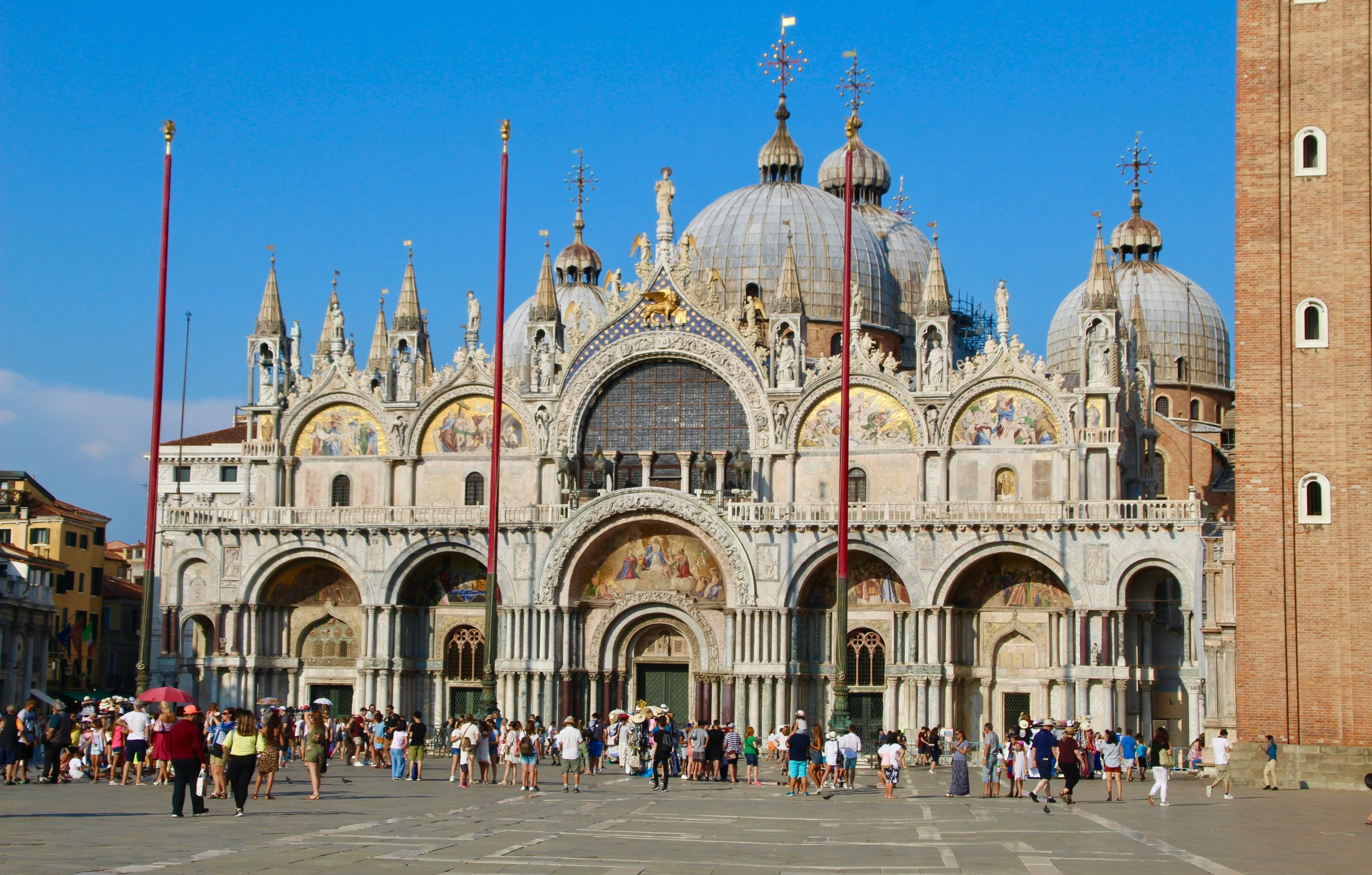 several people in front of a very tall cathedral