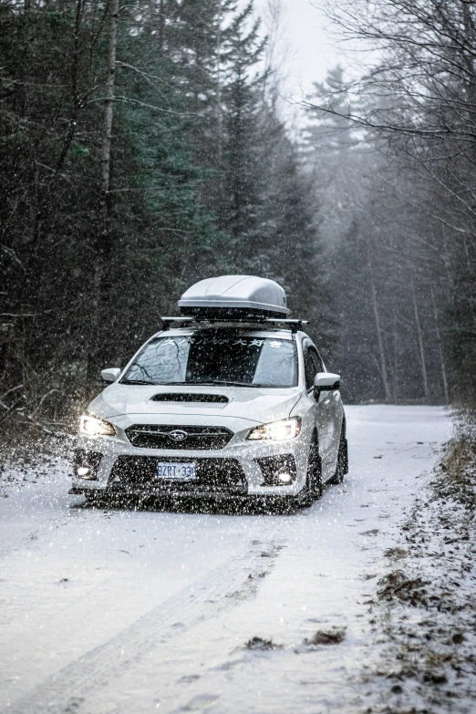 a car driving in the snow covered road