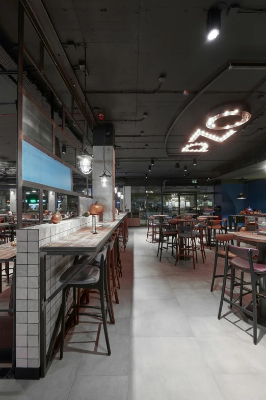 a dining area in an empty restaurant with tables and stools