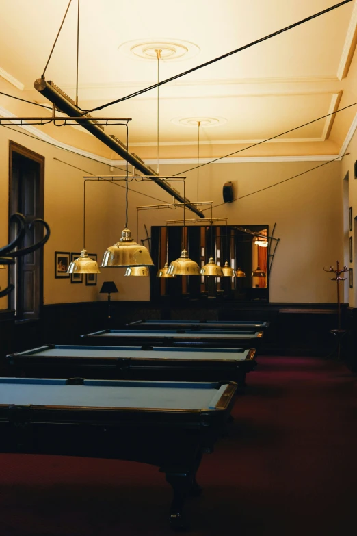 a long row of table with pool balls on the top of it