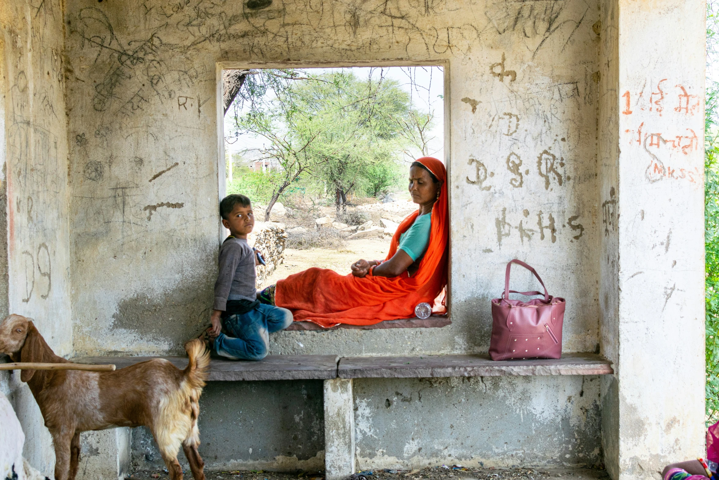 an image of two people sitting on a bench and one man is talking to him