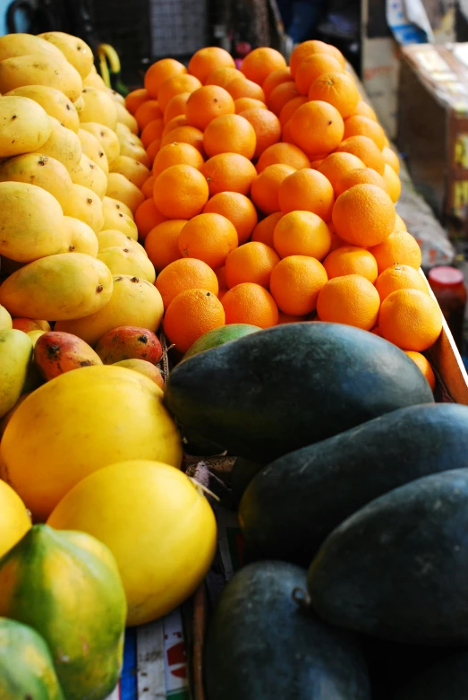 a display of various fruits in wooden containers