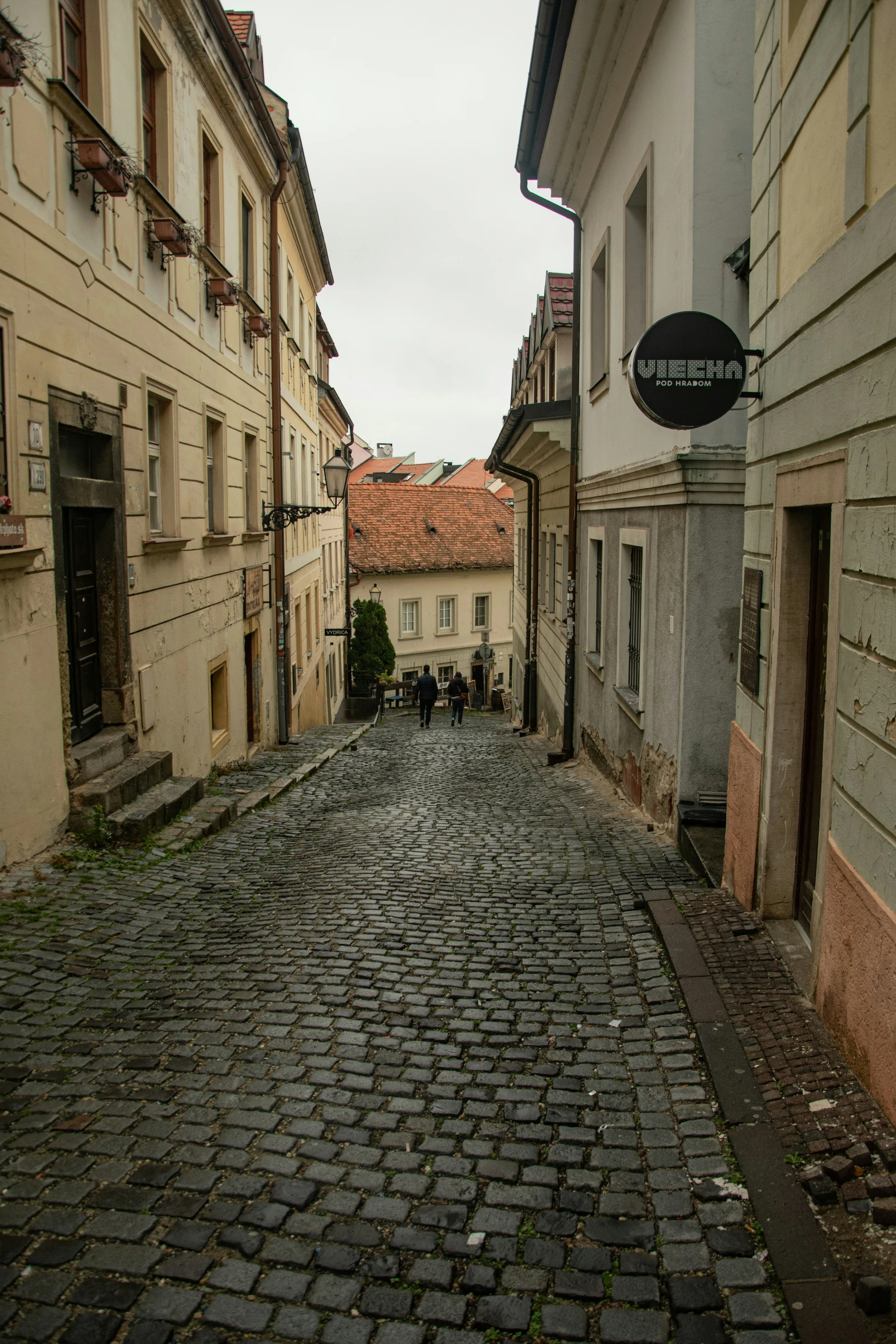 a street scene with old buildings and a cobblestone paved street