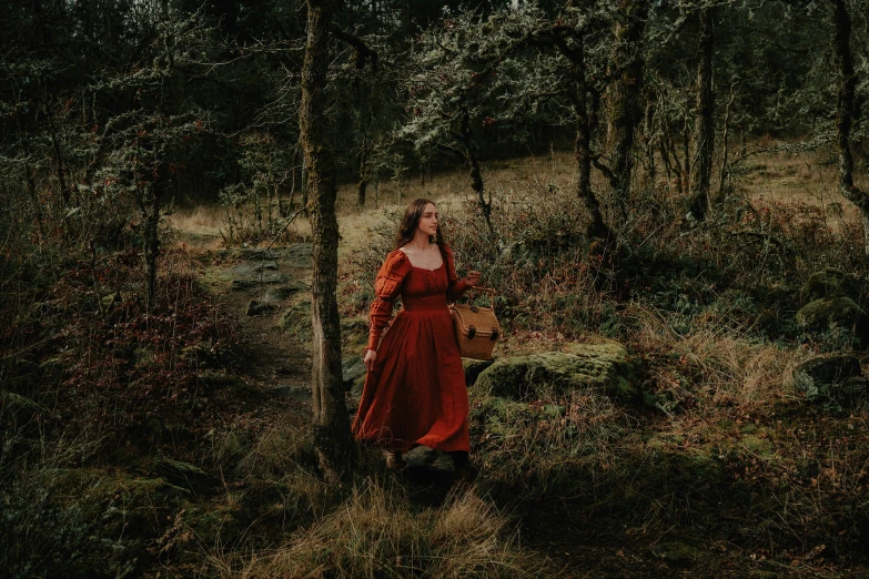 woman standing in forest holding a basket