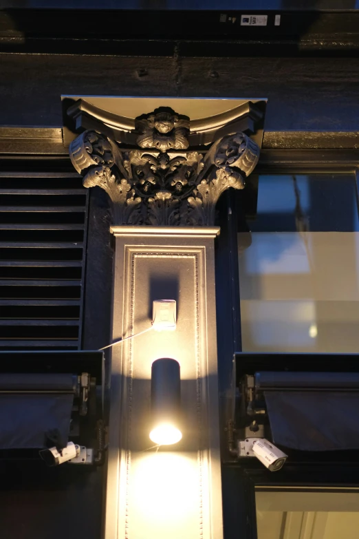 a street lamp is lit on an arched doorway