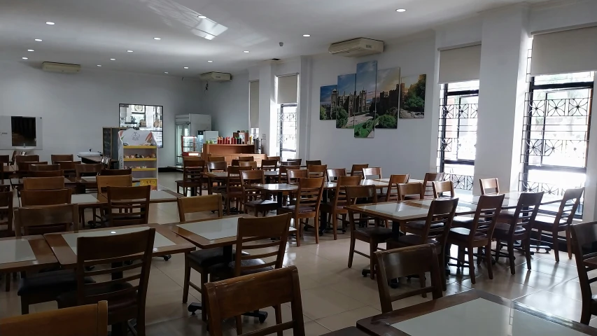 a dining area with multiple tables and several chairs