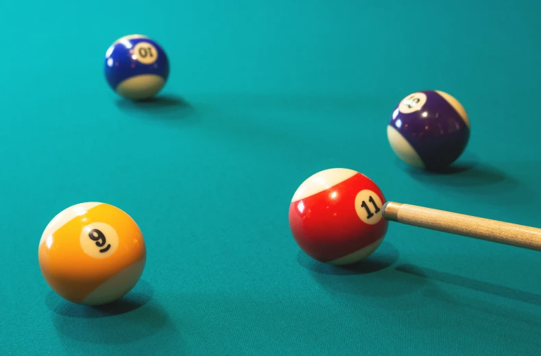 billiard balls on a pool table with cues