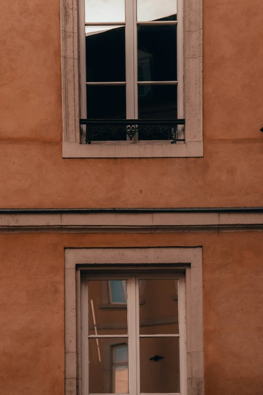 an old building with the windows reflecting off the side