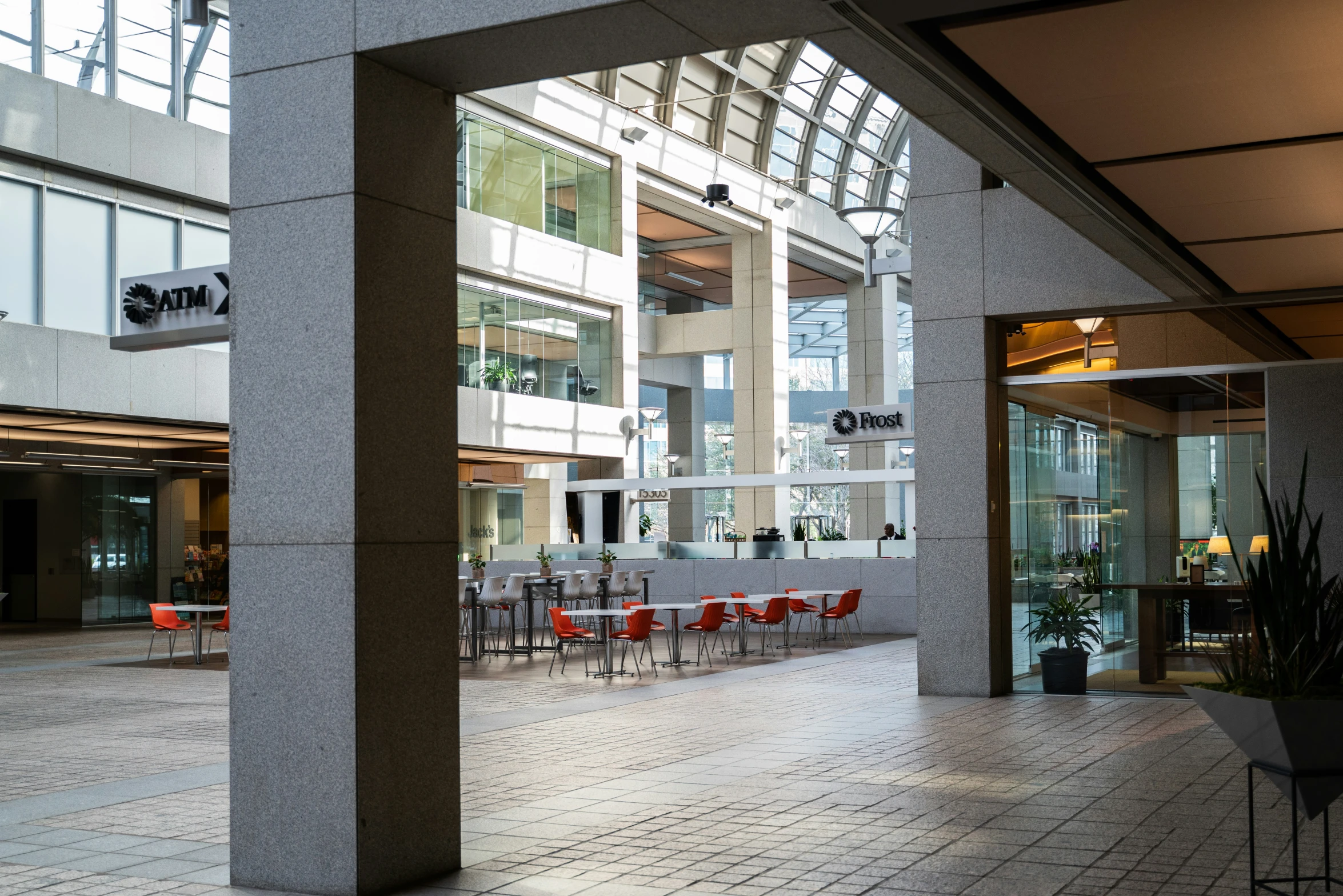 an indoor area that contains a table, chairs, and a plant