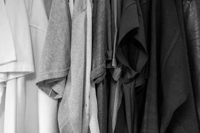 a group of pieces of clothing that are hung on hooks