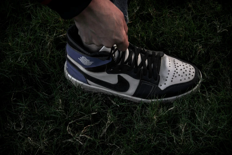 an foot stepping on the grass with nike shoes