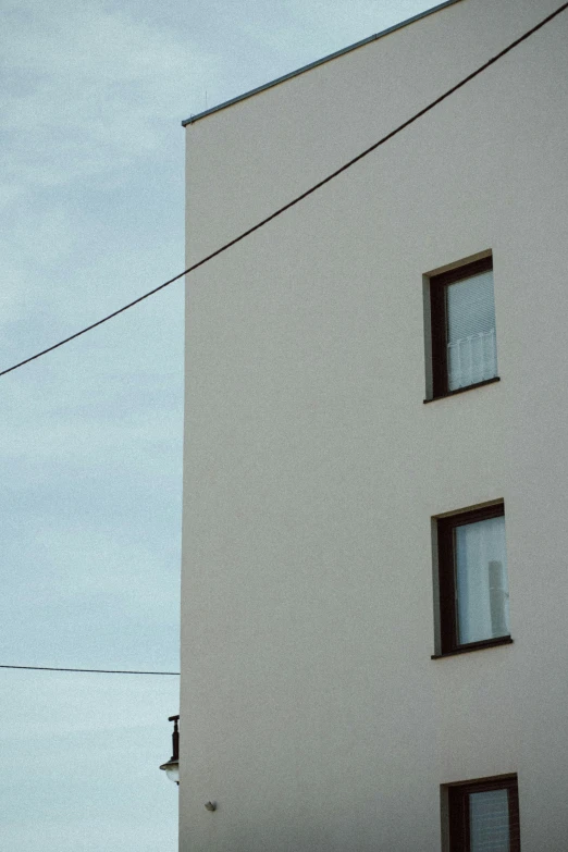 a tall white building with a clock on the side of it