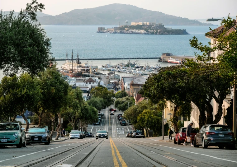 an empty street surrounded by lots of cars