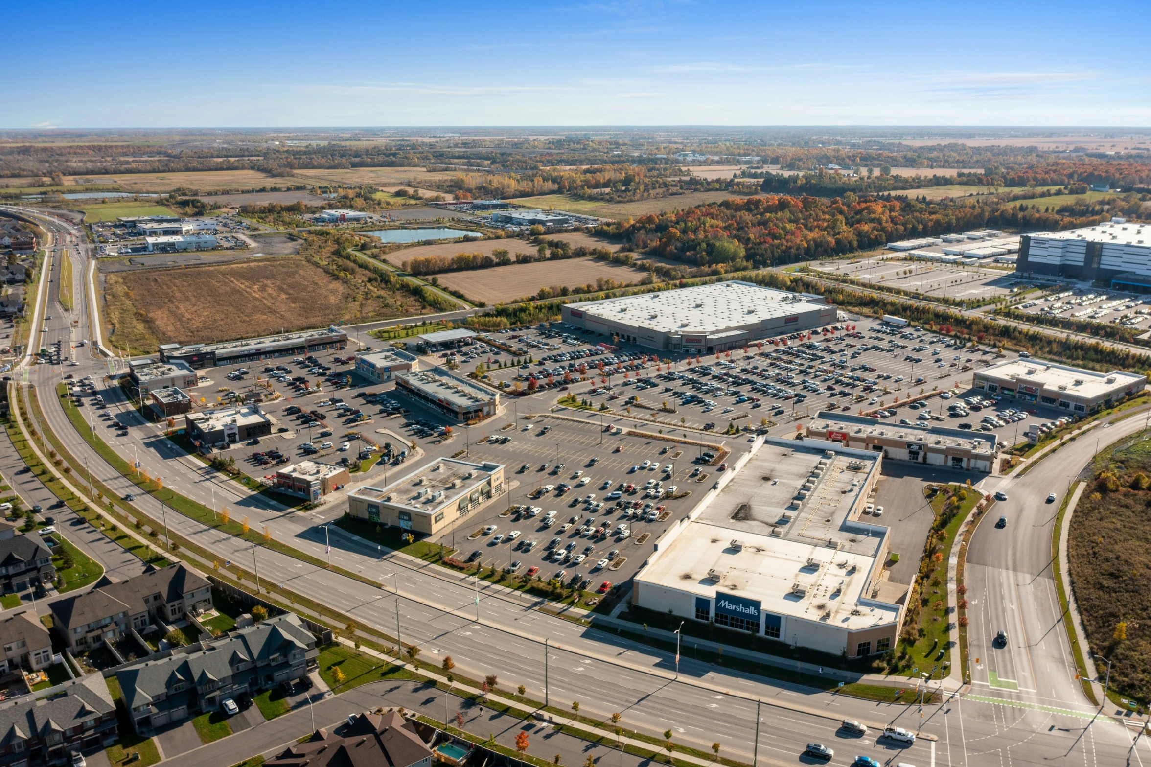 an aerial view of a shopping center with roads and parking spaces