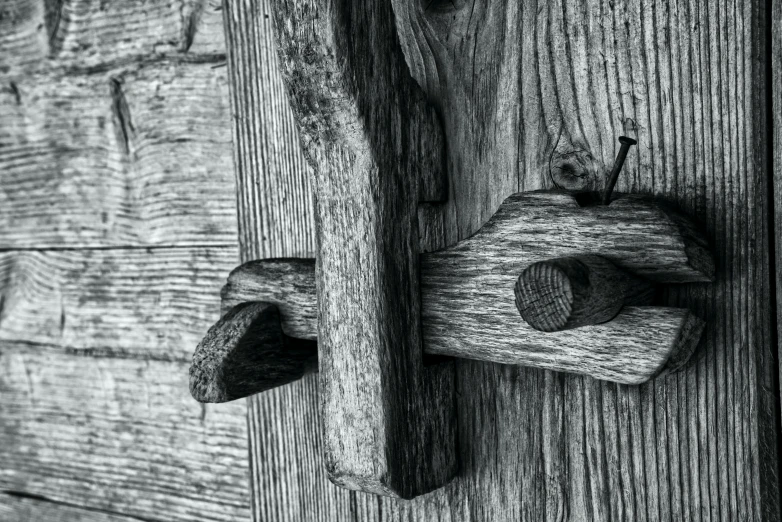 a close up of a door handle with wood