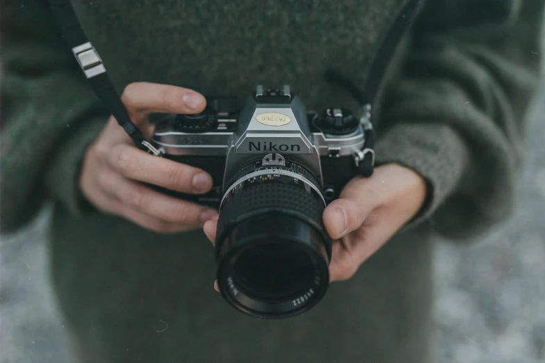 a person holding a camera on a city street