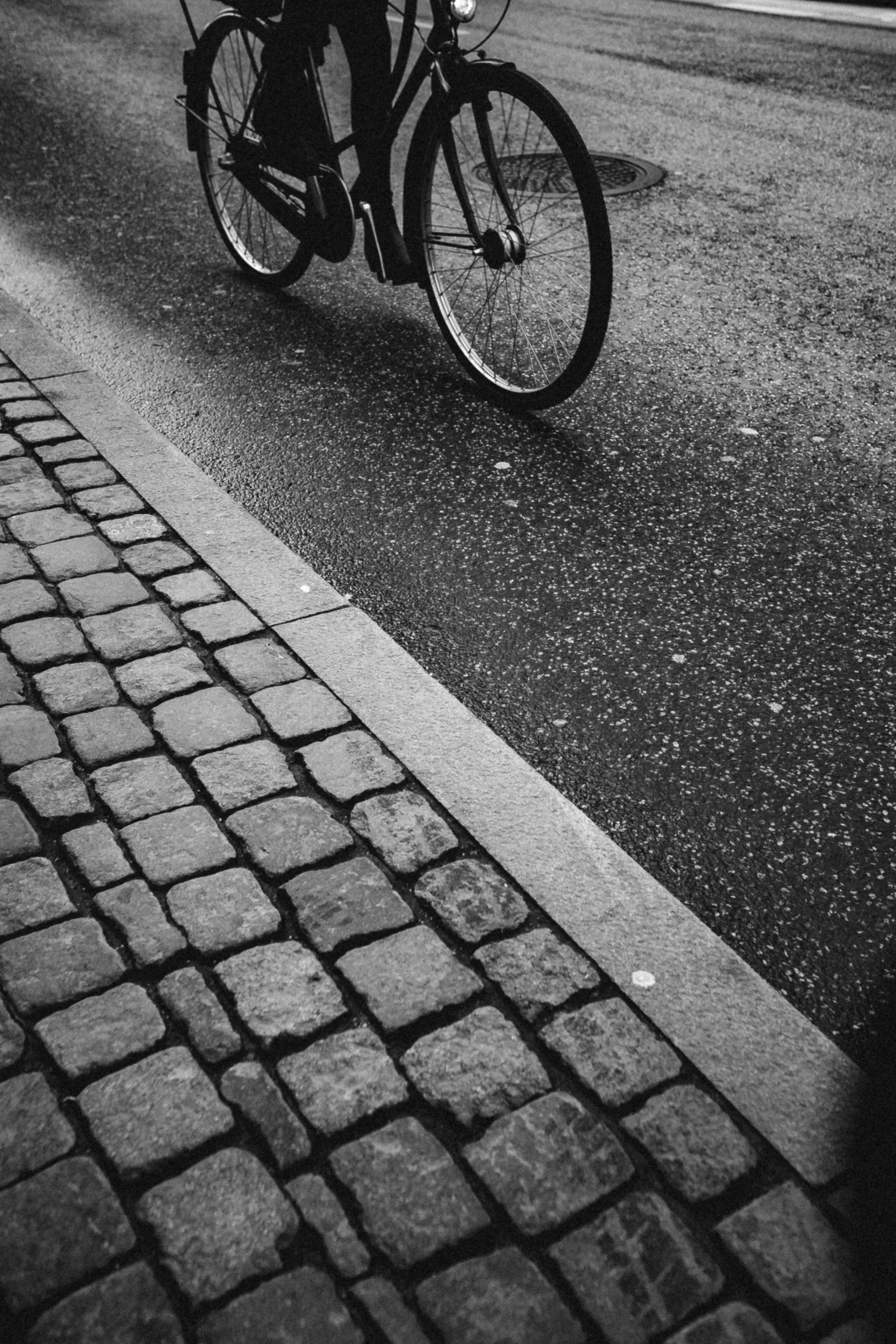 a man riding on the back of a bike down a street