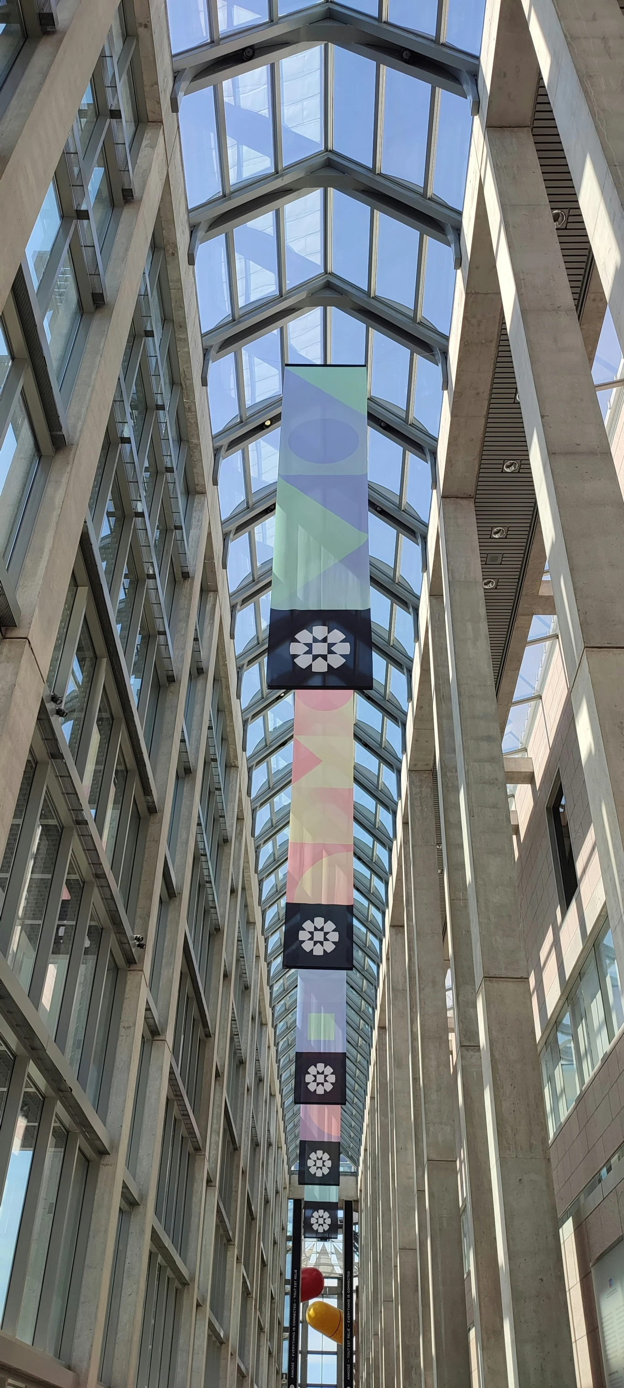 an open lobby filled with windows and flags