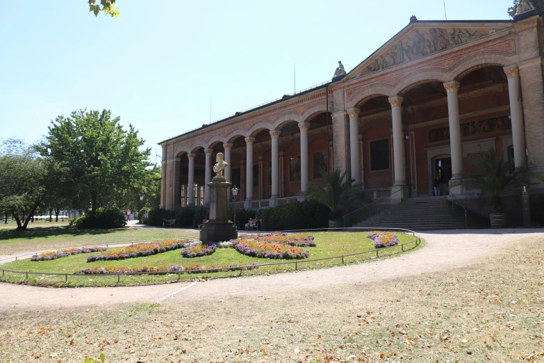 large circular lawn with flowers surrounding it