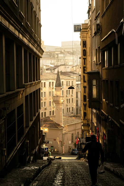 a view of an alley with people walking up and down the street