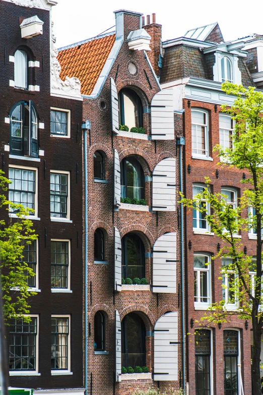 a row of red brick apartment buildings on a corner