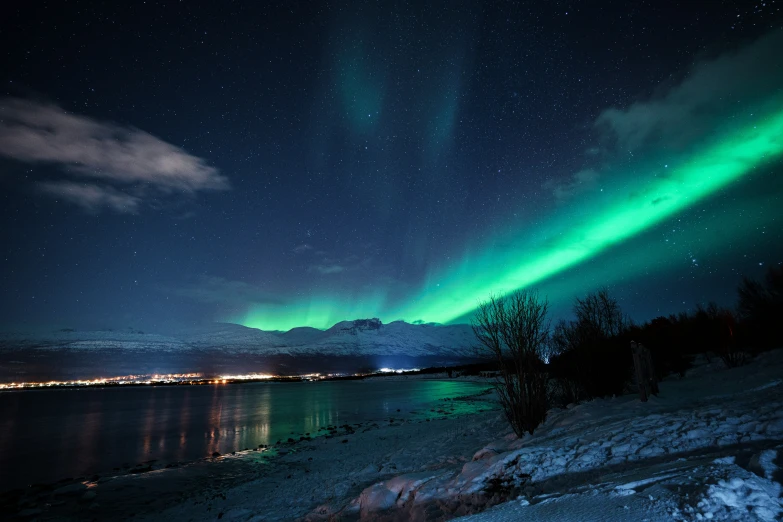 the aurora bore above an icy mountain lake