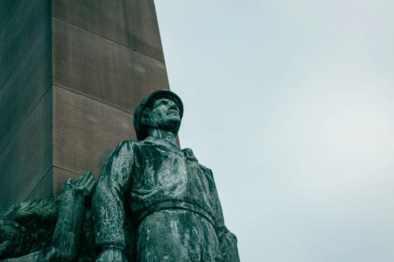 a large statue on top of a tall building