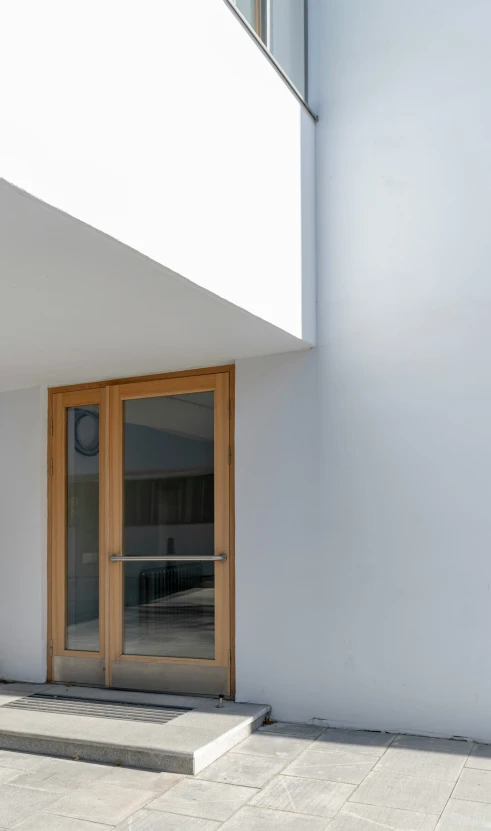 a wooden door sitting inside of a white building