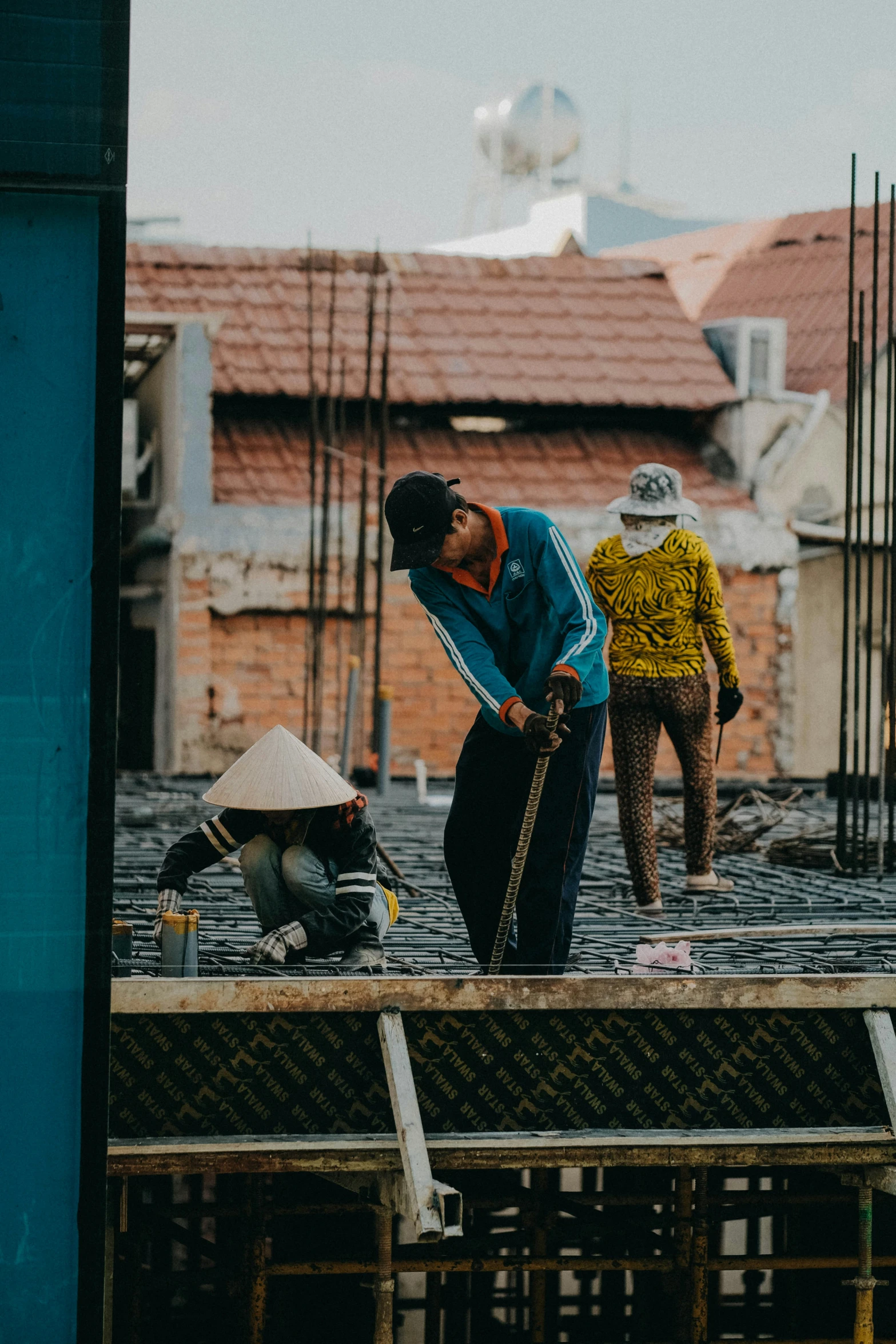 two people on top of a building under construction