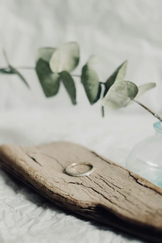 flowers in a glass vase and a wood board