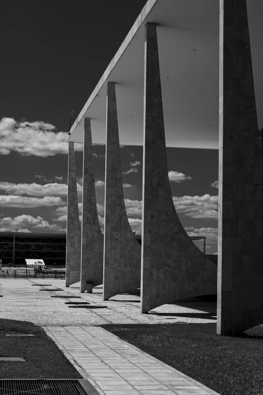 many pillars in black and white against the sky