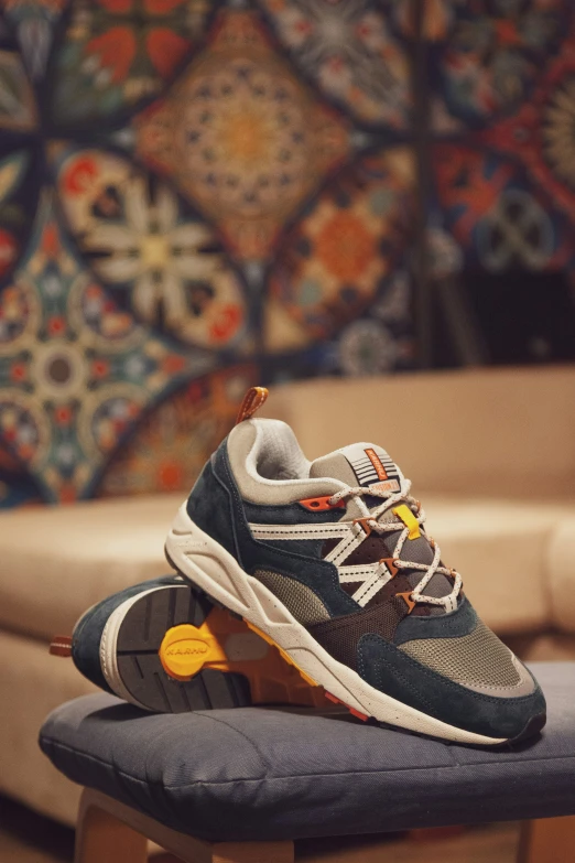 two pairs of blue and orange sneakers on a wooden bench