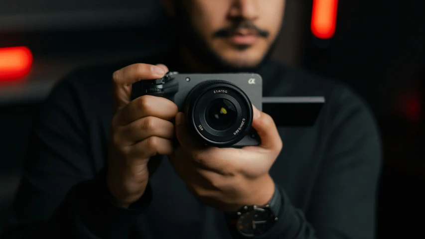 a person holding a camera in front of their face