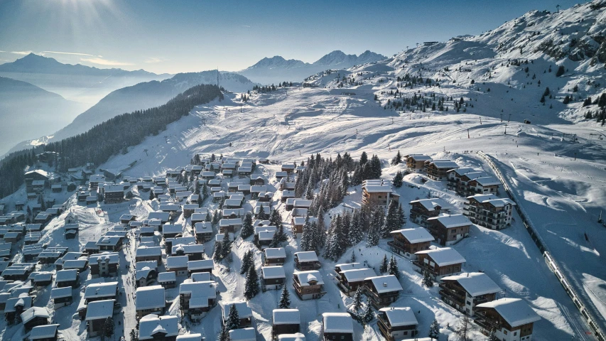 a snowy hillside with houses built into the side