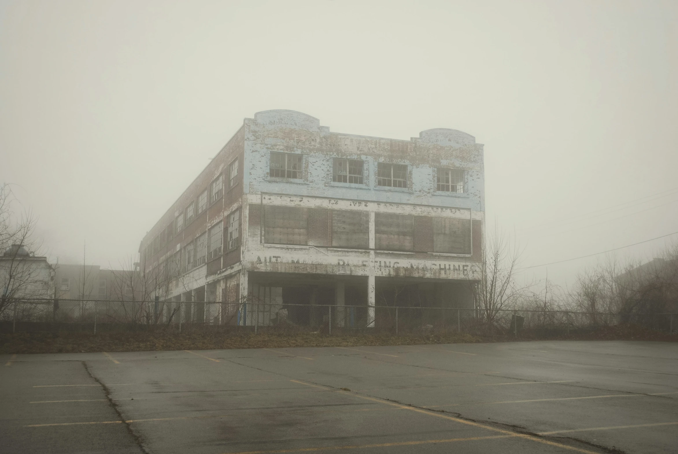 a building with lots of windows covered by a fog