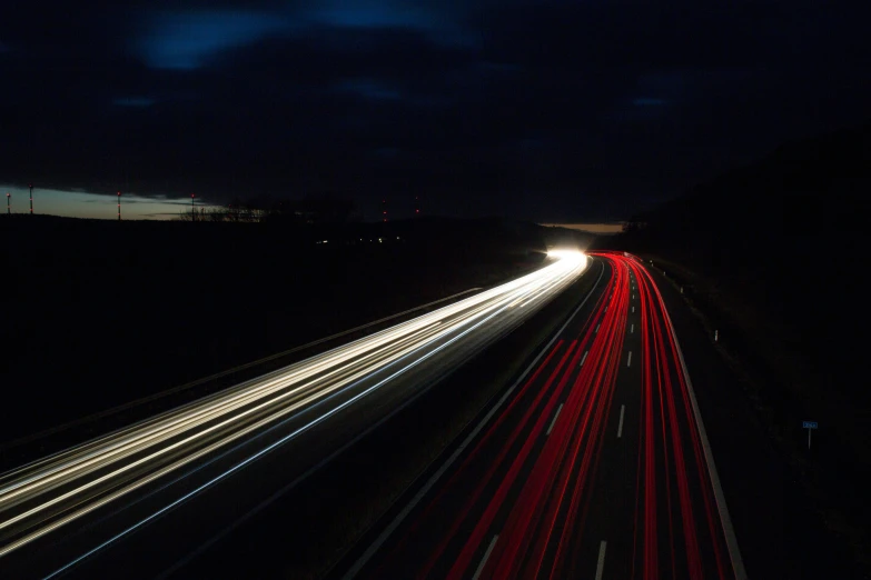 cars driving down the road with the lights shining