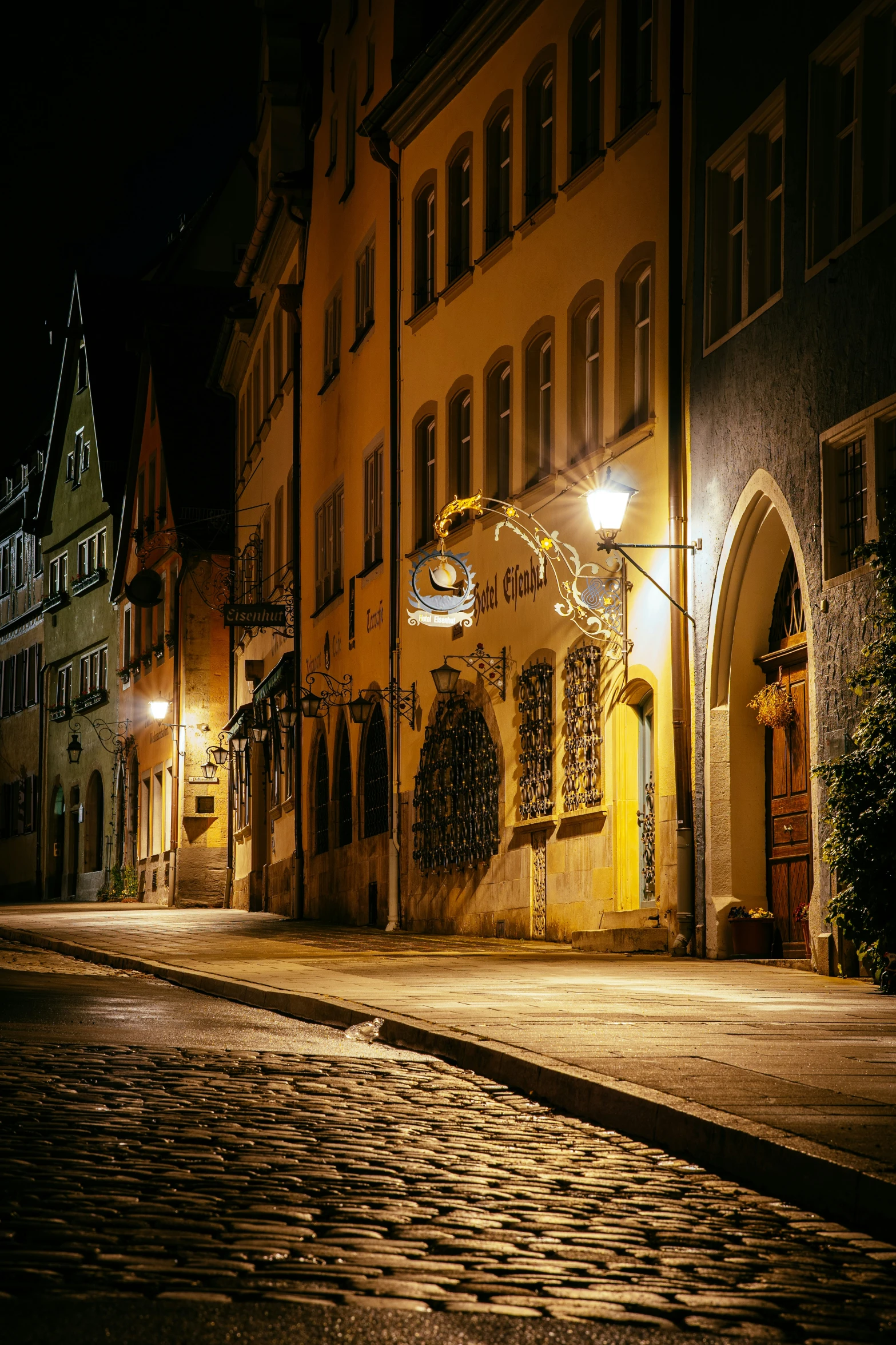 a night time s of some buildings on the street