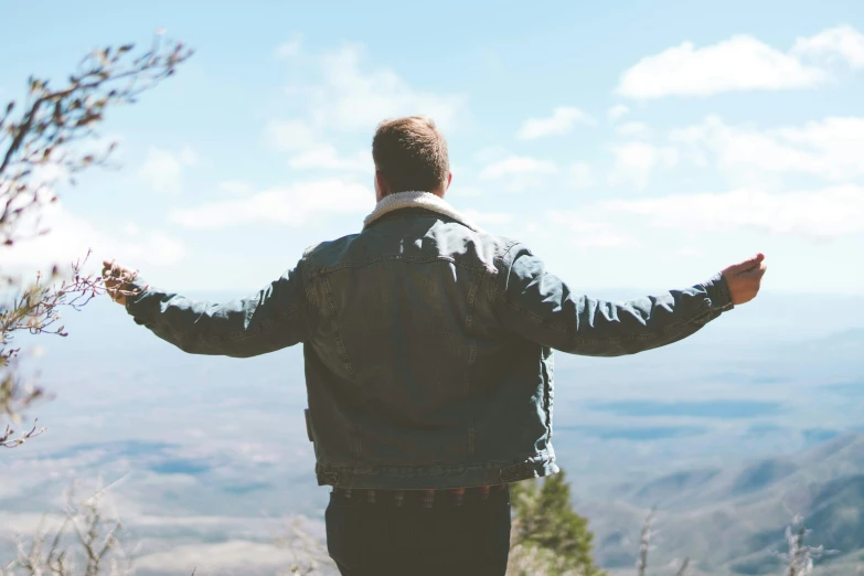 the back of the man is up high to take pictures of the scenery