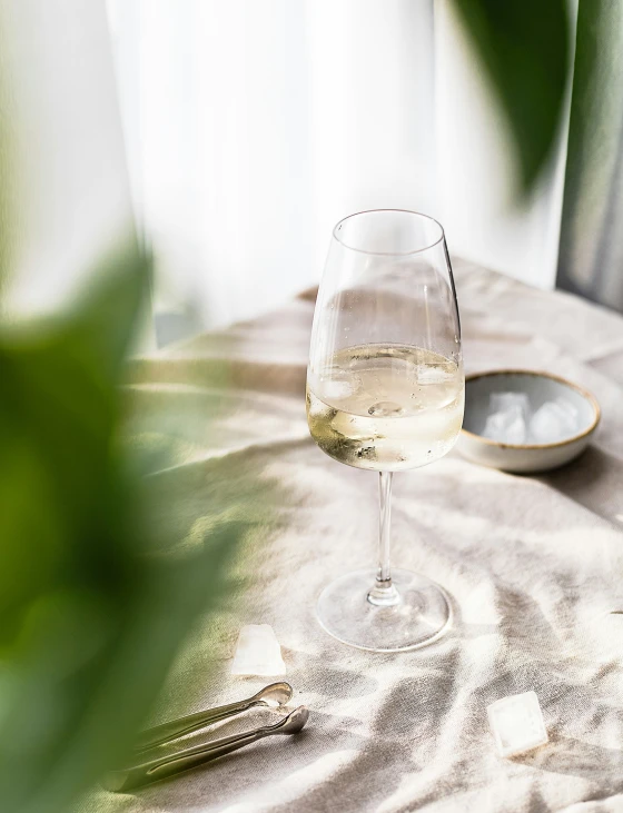 an empty wine glass is sitting on a table